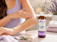 Woman applying NU SKIN botanical body oil to dry rough skin on her arm
